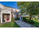 Inviting townhome featuring a well-manicured lawn and walkway leading to the front door at 2346 Silver Palm Dr, Kissimmee, FL 34747