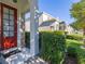 Inviting front porch features classic architectural details and meticulous landscaping at 2346 Silver Palm Dr, Kissimmee, FL 34747