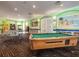 Well-lit game room with a pool table, ping pong, and arcade games for residents at 2346 Silver Palm Dr, Kissimmee, FL 34747