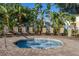 A tranquil hot tub area surrounded by lush tropical foliage and comfortable seating at 2346 Silver Palm Dr, Kissimmee, FL 34747