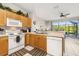 Well-equipped kitchen with appliances, wooden cabinets, and access to screened patio at 2346 Silver Palm Dr, Kissimmee, FL 34747