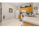 Efficient kitchen featuring white appliances, cabinetry, and a breakfast bar for casual dining at 2346 Silver Palm Dr, Kissimmee, FL 34747