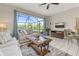 Inviting living room featuring plush seating and a large screened window with beautiful views at 2346 Silver Palm Dr, Kissimmee, FL 34747