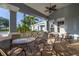 Covered outdoor patio seating area featuring comfortable chairs and tables with a ceiling fan at 2346 Silver Palm Dr, Kissimmee, FL 34747