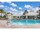 Inviting community pool area with lounge chairs, umbrellas, and views of the clubhouse at 2346 Silver Palm Dr, Kissimmee, FL 34747