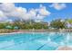 Large community pool with plenty of lounge chairs and umbrellas for a relaxing day outdoors at 2346 Silver Palm Dr, Kissimmee, FL 34747