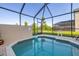 Enjoy the serenity of your screened-in pool with views of lush greenery at 2346 Silver Palm Dr, Kissimmee, FL 34747