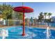 Close view of a community splash pad featuring water features and a red shade umbrella at 2346 Silver Palm Dr, Kissimmee, FL 34747