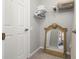Bright walk-in closet featuring a mirror, shelving, and a door at 2346 Silver Palm Dr, Kissimmee, FL 34747