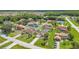 Drone shot showcases this neighborhood with many similar-style homes, mature trees, and a calm environment at 2445 Ravendale Ct, Kissimmee, FL 34758