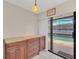 Dining area with dark wood cabinets and sliding glass doors leading to pool at 2445 Ravendale Ct, Kissimmee, FL 34758