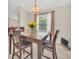 Dining area featuring a table, four chairs, neutral walls and floors, a chandelier, and natural light at 2445 Ravendale Ct, Kissimmee, FL 34758