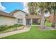 Close-up of the front entrance featuring a screened porch, manicured plants, and a cozy welcome at 2445 Ravendale Ct, Kissimmee, FL 34758