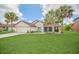 Lovely home showcasing green grass, mature landscaping, and a traditional architectural style at 2445 Ravendale Ct, Kissimmee, FL 34758