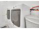 Clean and functional laundry room equipped with a modern washer and dryer unit and storage at 2445 Ravendale Ct, Kissimmee, FL 34758
