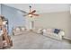A bright living room with tile floors, featuring a ceiling fan and comfortable seating at 2445 Ravendale Ct, Kissimmee, FL 34758