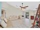 Comfortable living room with vaulted ceiling, ceiling fan, and access to the outdoor patio at 2445 Ravendale Ct, Kissimmee, FL 34758