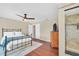 Cozy main bedroom with wooden floors, ceiling fan, and ensuite bathroom at 2445 Ravendale Ct, Kissimmee, FL 34758