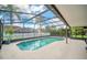 Enclosed pool with plenty of room for seating and a view of the backyard at 2445 Ravendale Ct, Kissimmee, FL 34758