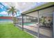Screened in pool area with patio seating and view of neighboring yard at 2445 Ravendale Ct, Kissimmee, FL 34758