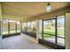 Enclosed porch with green plants, ample sunlight, and a view of the front yard and street at 2445 Ravendale Ct, Kissimmee, FL 34758