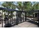 A beautiful balcony with black metal railing overlooking a tree-lined street at 2493 Lancien Ct # 5, Orlando, FL 32826