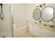 Bright bathroom featuring double sinks, shower/tub, and framed mirrors that provide style and functionality at 2493 Lancien Ct # 5, Orlando, FL 32826