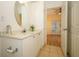 Bright bathroom with white vanity and tile floor viewed from bedroom at 2493 Lancien Ct # 5, Orlando, FL 32826