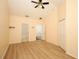 Spacious bedroom with wood-look floors, ceiling fan, and multiple doorways for easy access and flow at 2493 Lancien Ct # 5, Orlando, FL 32826