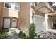 Inviting townhome entrance with a well-lit doorway, lovely floral wreath, and a manicured garden at 2493 Lancien Ct # 5, Orlando, FL 32826