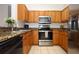 Stylish kitchen featuring stainless steel appliances, granite countertops, and ample cabinet space at 2493 Lancien Ct # 5, Orlando, FL 32826