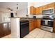 Open kitchen area with stainless steel appliances and granite countertops, leading into the living space at 2493 Lancien Ct # 5, Orlando, FL 32826