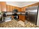 Modern kitchen with stainless steel appliances, granite countertops, and light wood cabinetry at 2493 Lancien Ct # 5, Orlando, FL 32826