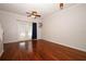 Bright living room with hardwood floors, ceiling fan, and French doors leading to the outdoor space at 2493 Lancien Ct # 5, Orlando, FL 32826