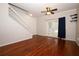 Spacious living room with hardwood flooring, ceiling fan, and stairs leading to the upper level at 2493 Lancien Ct # 5, Orlando, FL 32826