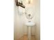 Charming powder room featuring a pedestal sink, oval mirror, and towel rack for added convenience at 2493 Lancien Ct # 5, Orlando, FL 32826