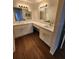 Bathroom featuring double vanity with modern fixtures, white cabinets, and wood flooring at 2723 Talladega Dr, Orlando, FL 32826
