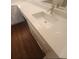 Modern bathroom vanity with white cabinets, stone countertop, and wood-style flooring at 2723 Talladega Dr, Orlando, FL 32826