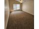 Spacious bedroom with neutral walls, plush carpet, and ample natural light from the large window at 2723 Talladega Dr, Orlando, FL 32826
