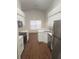 Modern kitchen with stainless steel appliances, white cabinets, and sleek countertops at 2723 Talladega Dr, Orlando, FL 32826