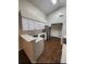 Updated kitchen with white cabinets, stainless steel appliances, and wood-look flooring at 2723 Talladega Dr, Orlando, FL 32826