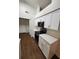 Well-lit kitchen with white cabinets, modern appliances, and wood-look flooring at 2723 Talladega Dr, Orlando, FL 32826