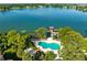 Picturesque aerial view of the community pool, dock, and lake with lush surroundings at 2945 Lake Pineloch Blvd # 18-26, Orlando, FL 32806