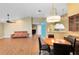Open-concept dining area showcasing wood floors, a ceiling fan and stylish hanging light fixture at 2945 Lake Pineloch Blvd # 18-26, Orlando, FL 32806