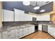 Stylish kitchen with white cabinetry, granite counters, and modern appliances at 2945 Lake Pineloch Blvd # 18-26, Orlando, FL 32806