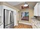 Bright kitchen featuring stainless steel refrigerator and a window view at 2945 Lake Pineloch Blvd # 18-26, Orlando, FL 32806