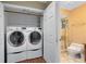 Well-equipped laundry room with a modern washer and dryer conveniently located near bathroom at 2945 Lake Pineloch Blvd # 18-26, Orlando, FL 32806