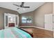 Spacious main bedroom featuring wood floors, ceiling fan, vaulted ceiling and an ensuite bathroom at 2945 Lake Pineloch Blvd # 18-26, Orlando, FL 32806
