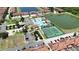 Aerial view of community amenities, including a clubhouse, pool, tennis and basketball courts at 2985 Buccaneer Palm Rd, Kissimmee, FL 34747