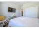 Comfortable bedroom featuring a queen bed, closet, tv and neutral decor at 2985 Buccaneer Palm Rd, Kissimmee, FL 34747